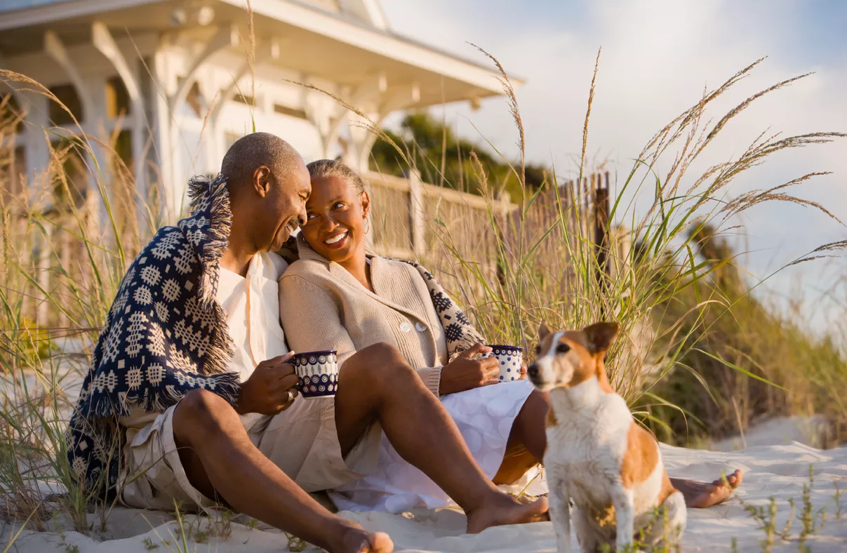 A older couple enjoying coffee on the beach 